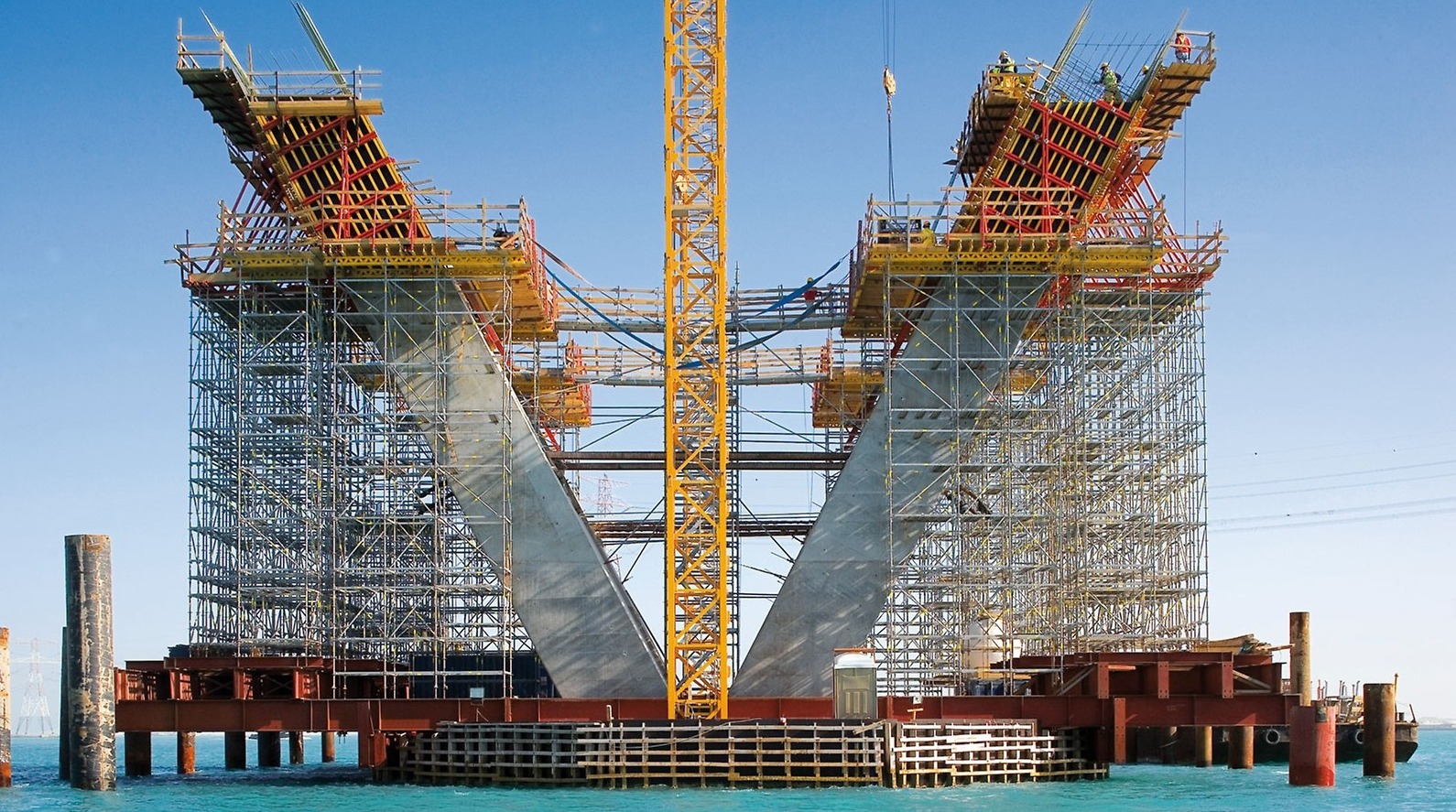 Large construction project with tower crane and scaffolding